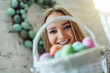 Happy easter! Beautiful young woman with basket of easter eggs.