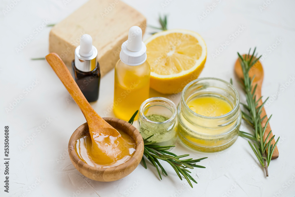 Natural skincare ingredients with manuka honey, lemon, essential oil, clay, balm, rosemary herbs and natural soap, healthy wellness and spa products , natural homemade ingredients - obrazy, fototapety, plakaty 
