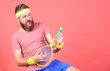 © be free - Having fun. Tennis active leisure. Athlete hipster hold tennis racket in hand red background. Tennis player vintage fashion. Tennis sport and entertainment. Man bearded hipster wear sport outfit