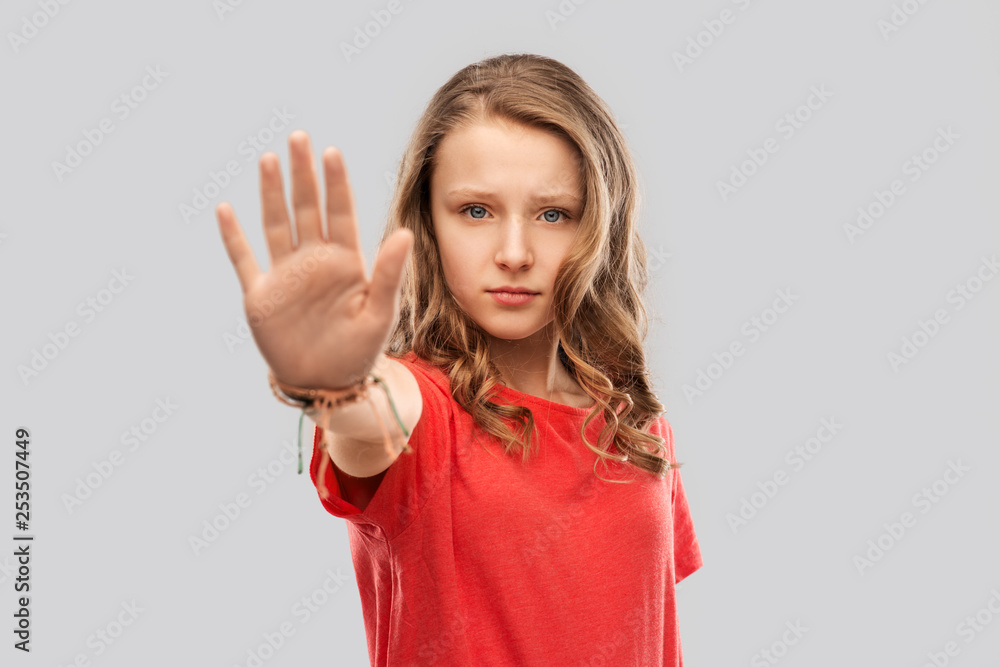 warning, prohibition and people concept - serious teenage girl in blank red t-shirt showing stop gesture over grey background - obrazy, fototapety, plakaty 