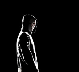 Computer hacker in hoodie. Obscured dark face. Data thief, internet fraud, darknet and cyber security concept.