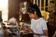 © Joshua Resnick - thai teen girl doing homework and studying at home