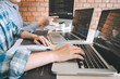 © Ngampol - Team of Professional Developer programmer cooperation meeting and brainstorming and programming in website working a software and coding technology, writing codes and database