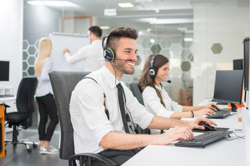 Wall Mural - Cheerful customer service agents working in call center