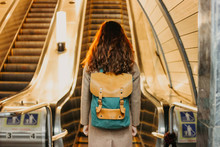Young Woman Curly Red Head Girl Traveller With Backpack And Map In Subway Station In Front Of Escalator