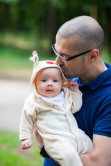 father holding and kissing his little daughter