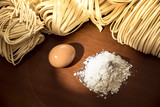 Fototapeta Młodzieżowe - Homemade noodles flour and eggs on wooden table