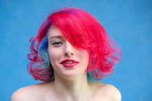 High Fashion Model Woman With Multi-colored Hair Posing In The Studio, Portrait Of A Beautiful Sexy Girl With A Fashionable Makeup And Manicure.