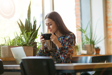 Wall Mural - young woman with laptop in cafe