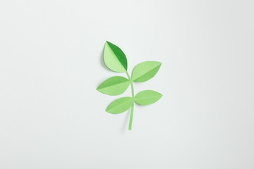 Sticker - top view of green paper plant with leaves on grey background