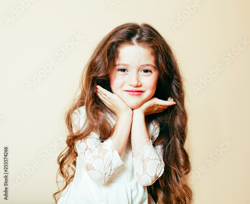 Little Cute Girl With Long Curly Hair Posing Cheerful On White