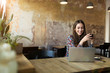 © pikselstock - Young woman with laptop in cafe