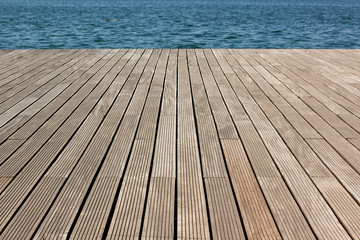 simple background pattern concept surface of wooden deck floor perspective photography with view on swimming pool blue water , copy space