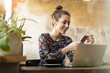 © pikselstock - Young woman with laptop in cafe