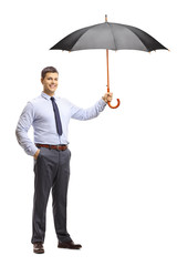 Canvas Print - Young man holding an umbrella and smiling