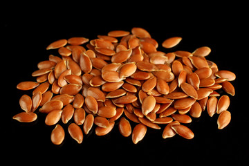 Sticker - Seeds of flax on a black background close up