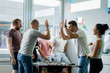© Yuliya Kirayonak - happy managers playing table football at office and having fun together