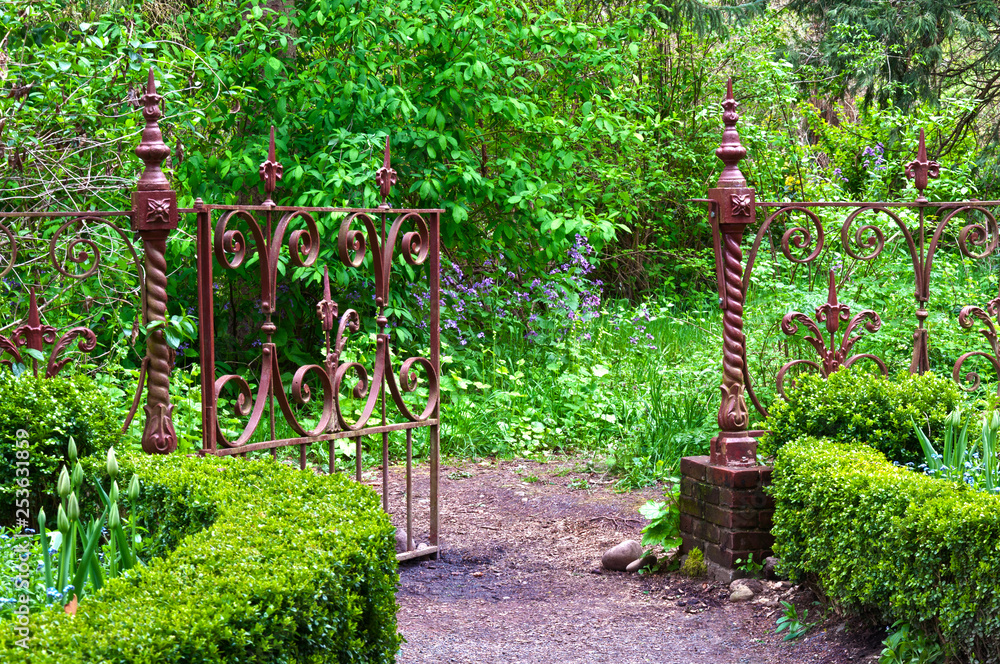 English garden with wrought iron gate Stock Photo | Adobe Stock