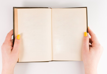 Hands holding opened book. Blank paper Mock-up