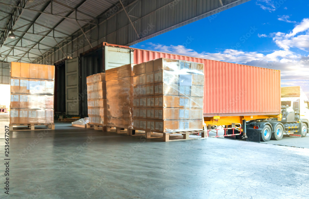 Cargo freight, Shipment, Delivery service. Logistics and transportation. Warehouse dock load pallet goods into shipping container truck. Stacked package boxes on pallets waiting to load into a truck. - obrazy, fototapety, plakaty 