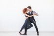 © satura_ - Social dance, kizomba, tango, salsa, people concept - beautiful couple dancing bachata on white background with copy space