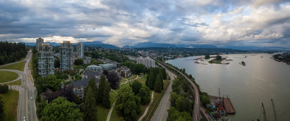 Aerial Panoramic view of residential homes in a modern city during a vibrant summer sunset. Taken in New Westminster, Vancouver, BC, Canada.