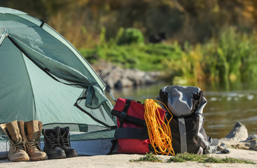 set of equipment near camping tent outdoors