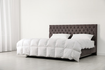 Sticker - Comfortable bed with new mattress near wall in room. Healthy sleep