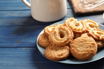 Plate with Danish butter cookies on table. Space for text