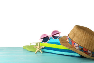 Set of beach accessories on table against white background. Space for text