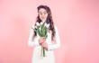 © puhimec - Young girl with tulips on a colored background