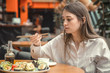 © puhimec - Young Woman eating and enjoying fresh sushi