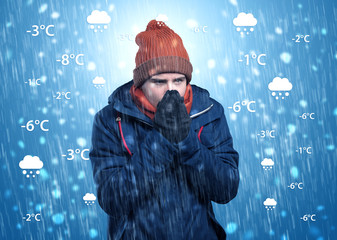 young man freezing in warm clothing with weather condition and forecast concept
