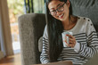© Jacob Lund - Asian woman relaxing at home using laptop