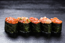 Shrimp, Salmon, Scallop, Tuna Gunkanmaki Stacked Side By Side Against Slate Backround
