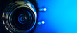 The camera lens and blue backlighting . Horizontal photography. Banner
