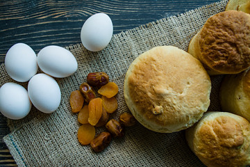 Wall Mural - Easter cake on a dark background. Fresh cakes with dried fruits. The process of making Easter cakes. View from above.