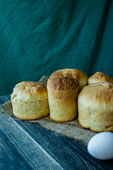 Wall Mural - Easter cake on a dark background. Fresh cakes with dried fruits. The process of cooking Easter cake. View from the side.