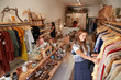 © Monkey Business - Customers Browsing In Independent Clothing And Gift Store