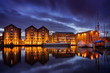 Gloucester docks at night with reflection of warehouses and boats