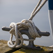 Boat mooring rope tied around bollard