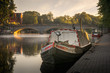 Narrow boat on a misty river avon in Evesham with Workman bridge in the background