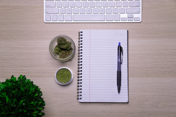 Flat lay, Top view office table desk, Workspace with marijuana buds, keyboard, and office supplies