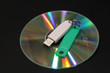 © MIKHAIL BATURITSKII	 - CD with color beams and electronic key on a dark background. Correction fluid,electronic key, DVD with color rays of a rainbow, a notebook,record marker  and a pen on a dark background