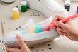 Girl painting white slip-on shoes