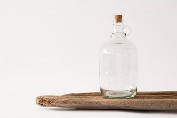 Mockup of a large empty glass growler bottle on a white table.