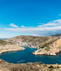 Balaklava bay in Crimea, mountain cliffs and sea port with ships. Beautiful nature panorama landscape, town among hills and black sea coast. Summer travel concept