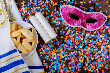 Jewish holiday Purim with carnival mask and hamantaschen cookies. Flat lay