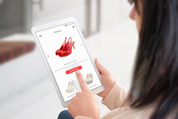 Wall Mural - Woman buy shoes online with tablet.