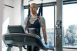 © Inti St. Clair - Man in physical therapy harness on a treadmill